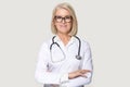 Portrait of mature female doctor isolated on grey background Royalty Free Stock Photo