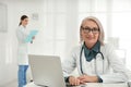 Portrait of mature female doctor in white coat Royalty Free Stock Photo