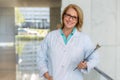 Portrait of a mature female medical staff doctor at hospital, genuine warm smile, qualified practitioner, experienced physician Royalty Free Stock Photo