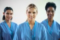 Portrait Of Mature Female Multi Cultural Medical Team Wearing Scrubs In Hospital Royalty Free Stock Photo