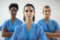 Portrait Of Mature Female Multi Cultural Medical Team Wearing Scrubs In Hospital Royalty Free Stock Photo