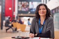 Portrait Of Mature Female Teacher Or Student With Digital Tablet Working At Table In College Hall Royalty Free Stock Photo