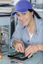 Portrait mature female technician working in office