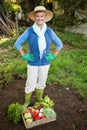 Portrait of mature gardener with vegetables crate at garden Royalty Free Stock Photo