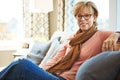 Portrait, mature or happy woman on sofa to relax with freedom on living room couch at home. Apartment, glasses or senior Royalty Free Stock Photo
