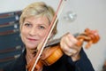 Portrait mature lady playing violin Royalty Free Stock Photo