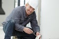 Portrait mature male electrician installing socket Royalty Free Stock Photo