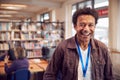 Portrait Of Mature Male Teacher Or Student In Library With Other Students Studying In Background Royalty Free Stock Photo