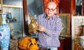 Portrait of mature man choosing vintage goods at antiques shop Royalty Free Stock Photo