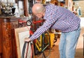 Portrait of mature man choosing vintage goods at antiques shop Royalty Free Stock Photo