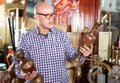 Portrait of mature man choosing vintage goods at antiques shop Royalty Free Stock Photo