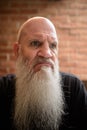 Portrait of mature man looking angry with long gray beard Royalty Free Stock Photo