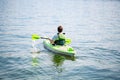 Portrait of mature man paddling a kayak in a lake. Senior caucasian man canoeing on summer day.