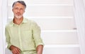 Portrait, mature man and positive on stairs in confidence in career and mockup in studio. Person, happy face and senior Royalty Free Stock Photo