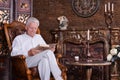 Portrait of mature man reading book at room Royalty Free Stock Photo