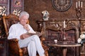 Portrait of mature man reading book at room Royalty Free Stock Photo