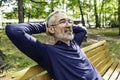 Portrait of a mature man sitting on a bench in an urban park Royalty Free Stock Photo