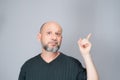 Portrait of mature man standing on white background. Bald bearded man making gestures