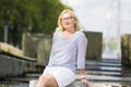 Portrait of Mature Middle Aged smiling Blond Woman Wearing Spectacles Posing Outdoors