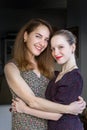 Portrait of a mature mother and her teenage daughter looking camera. Royalty Free Stock Photo