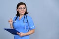 Portrait of mature nurse woman holding clipboard Royalty Free Stock Photo