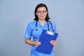 Portrait of mature nurse woman holding clipboard Royalty Free Stock Photo