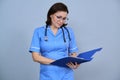 Portrait of mature nurse woman holding clipboard Royalty Free Stock Photo