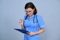 Portrait of mature nurse woman holding clipboard Royalty Free Stock Photo