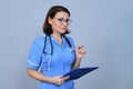 Portrait of mature nurse woman holding clipboard Royalty Free Stock Photo