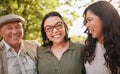 Portrait, mature parents and daughter laugh at retirement joke, goofy park journey or funny humour in wellness garden