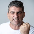 Portrait of a mature 40s to 50s white angry and upset man looking furious and aggressive human emotions facial expressions and Royalty Free Stock Photo