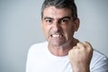 Portrait of a mature 40s to 50s white angry and upset man looking furious and aggressive human emotions facial expressions and Royalty Free Stock Photo