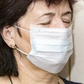 Portrait of a mature sick woman in a medical mask