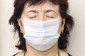 Portrait of a mature sick woman in a medical mask