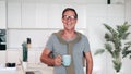 portrait of a mature successful man looking at the camera and smiling and holding a cup of coffee or tea in his hands Royalty Free Stock Photo