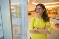 Portrait of happy mature woman thinking inside shopping mall Royalty Free Stock Photo