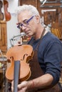 Portrait of mature violin maker Royalty Free Stock Photo