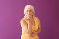 Portrait of mature woman blowing kiss on color background Royalty Free Stock Photo