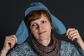 Portrait of mature woman in blue cap being happy