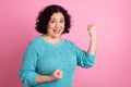 Portrait of mature woman doing a winner gesture hands up screaming yes  on pastel color background Royalty Free Stock Photo