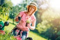 Portrait of mature woman gardening at home.