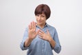 Portrait of mature woman making stop sign with her hand. Royalty Free Stock Photo