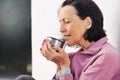 Portrait of mature woman resting after jog in the park with cup of hot tea Royalty Free Stock Photo