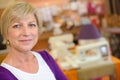 Portrait mature woman sewing machine in background Royalty Free Stock Photo