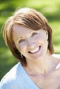 Portrait Of Mature Woman Sitting In Field Royalty Free Stock Photo