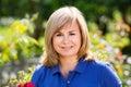 Portrait of mature woman standing in garden Royalty Free Stock Photo