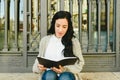 Portrait mature woman taking notes in her notebook, reading plans, front view Royalty Free Stock Photo