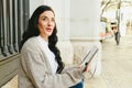 Portrait mature woman taking notes in her notebook, reading plans, side view Royalty Free Stock Photo