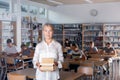 Portrait of mature woman teacher standing with books Royalty Free Stock Photo