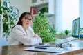 Portrait of mature woman working at home on computer laptop Royalty Free Stock Photo